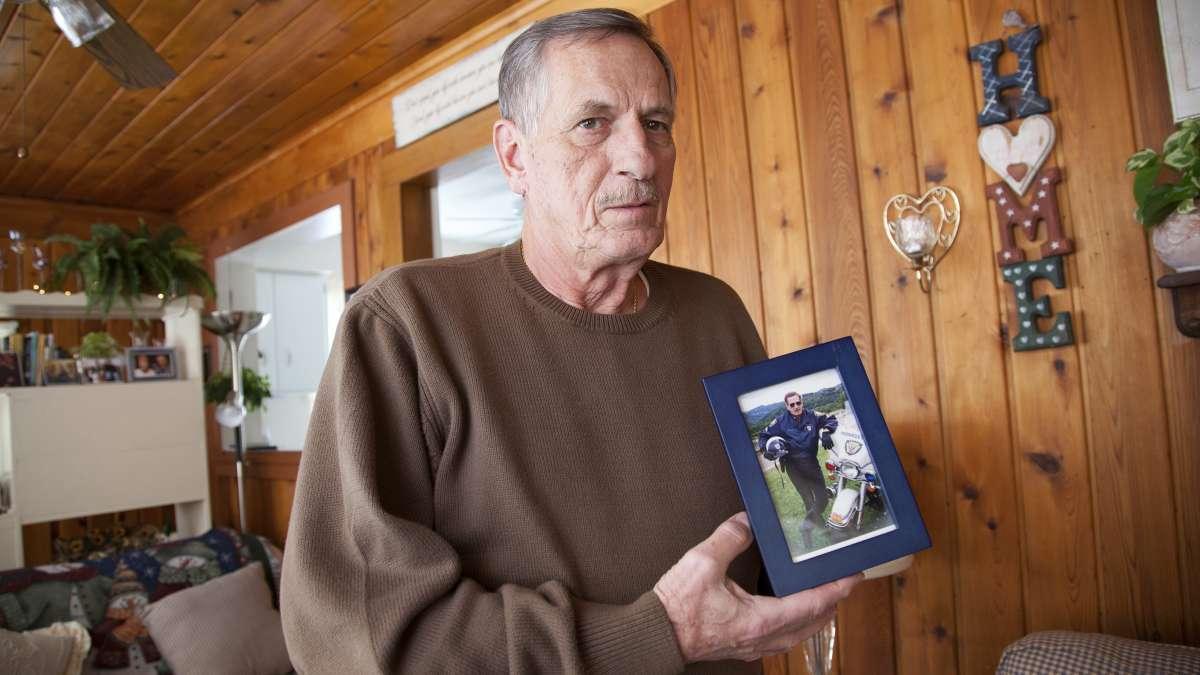 Pennsylvania's pension problem: Joe Rosipal, 70, a retired Monroeville police officer, with a photograph of himself in his 40s, when he was part of the motorcycle division. Irina Zhorov/WESA
