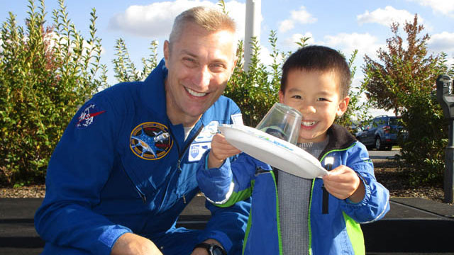 Astronaut James Pawelczyk with a young guest at the WPSU Cosmic Carnival
