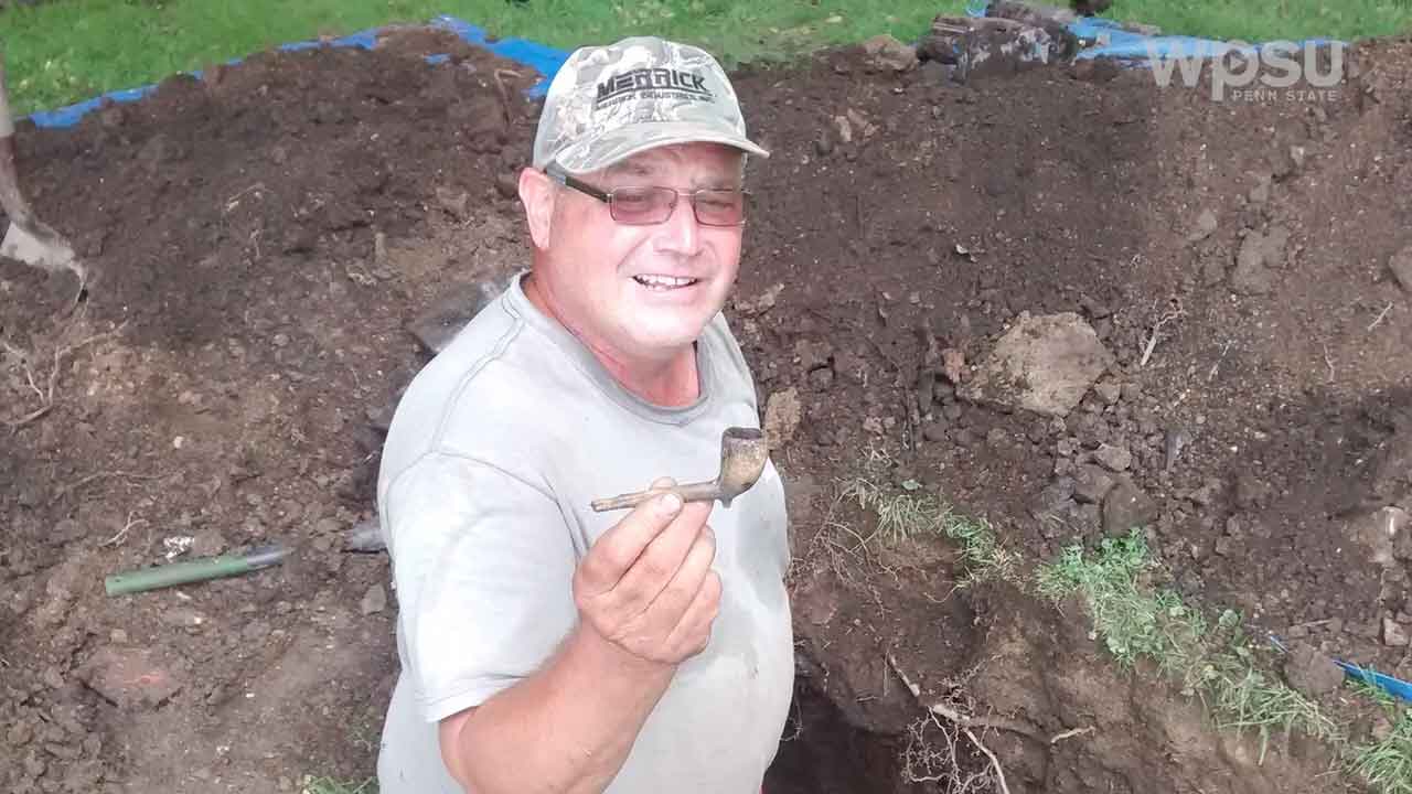 frank show a pipe he dug from the ground to the camera