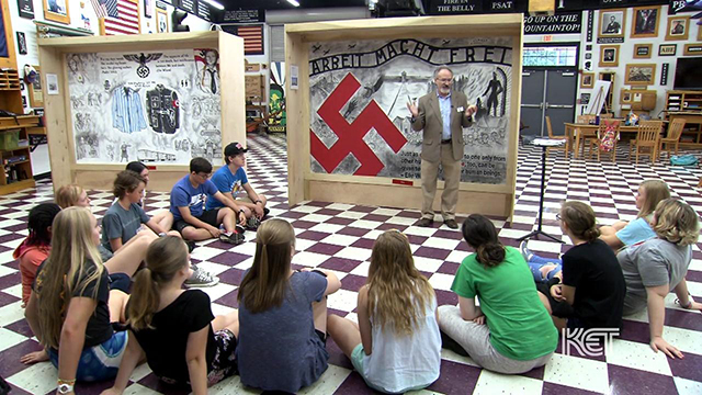 presenter speaking to students about a mural