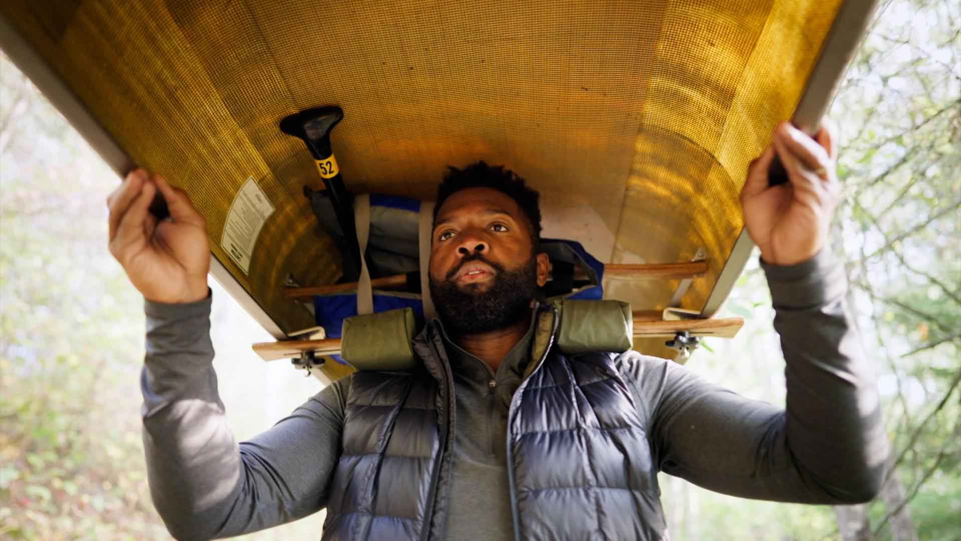 Baratunde Thurston carrying kayak above his head