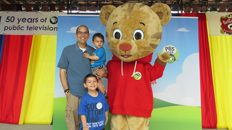 Daniel Tiger character posing with a family