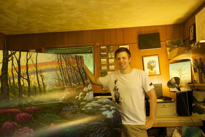 Local artist Sean Bodley stands next to his completed bench.