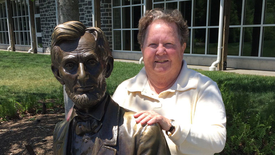 Carol Reardon with bronze statue of Abraham Lincoln