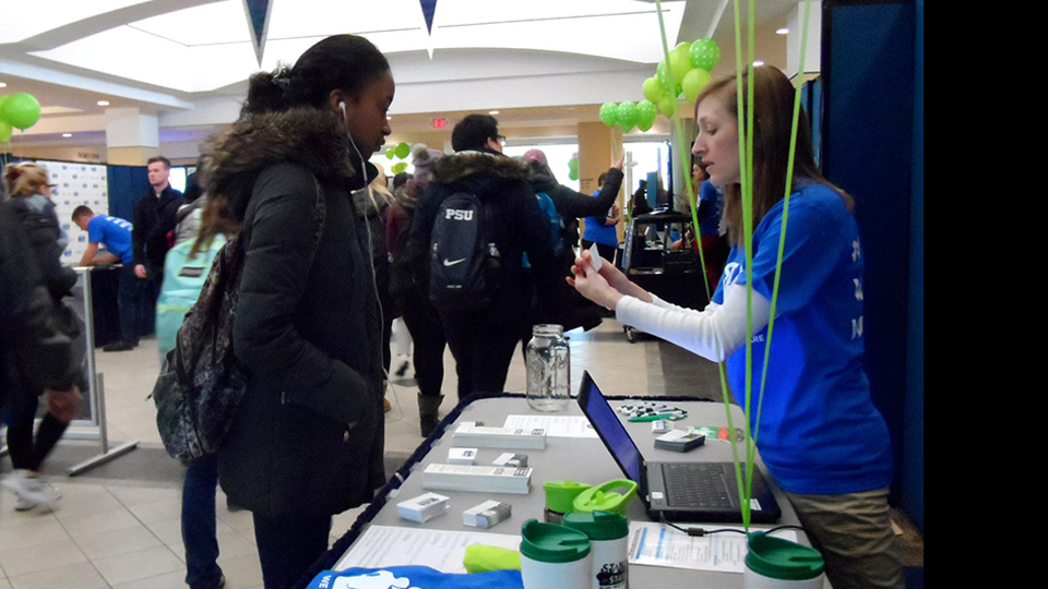A student gets information from a Stand for State volunteer. The bystander intervention program held its launch event in the HUB on Wednesday.