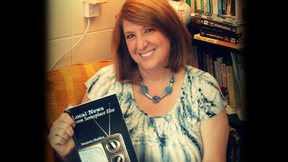 Reviewer Marjorie Maddox with her book of poetry.