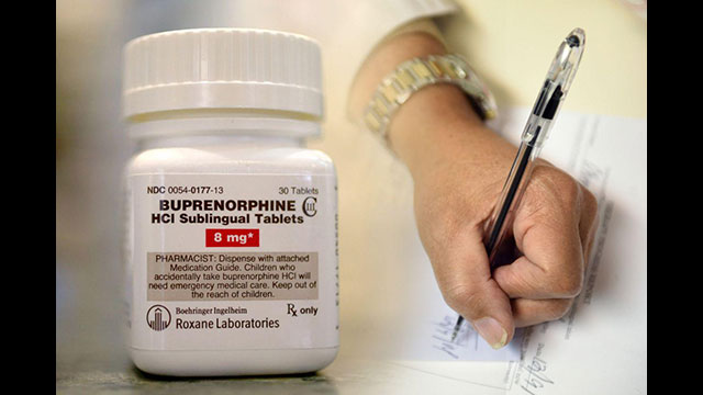 A physician writes a prescription for buprenorphine.