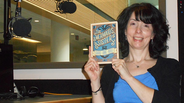 Local author Carrie Anne Noble shows off her debut novel.