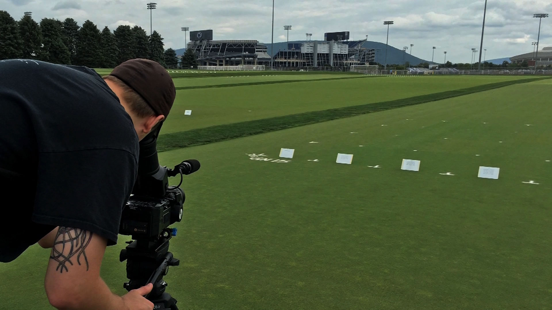 Videographer shoots video of turf grass