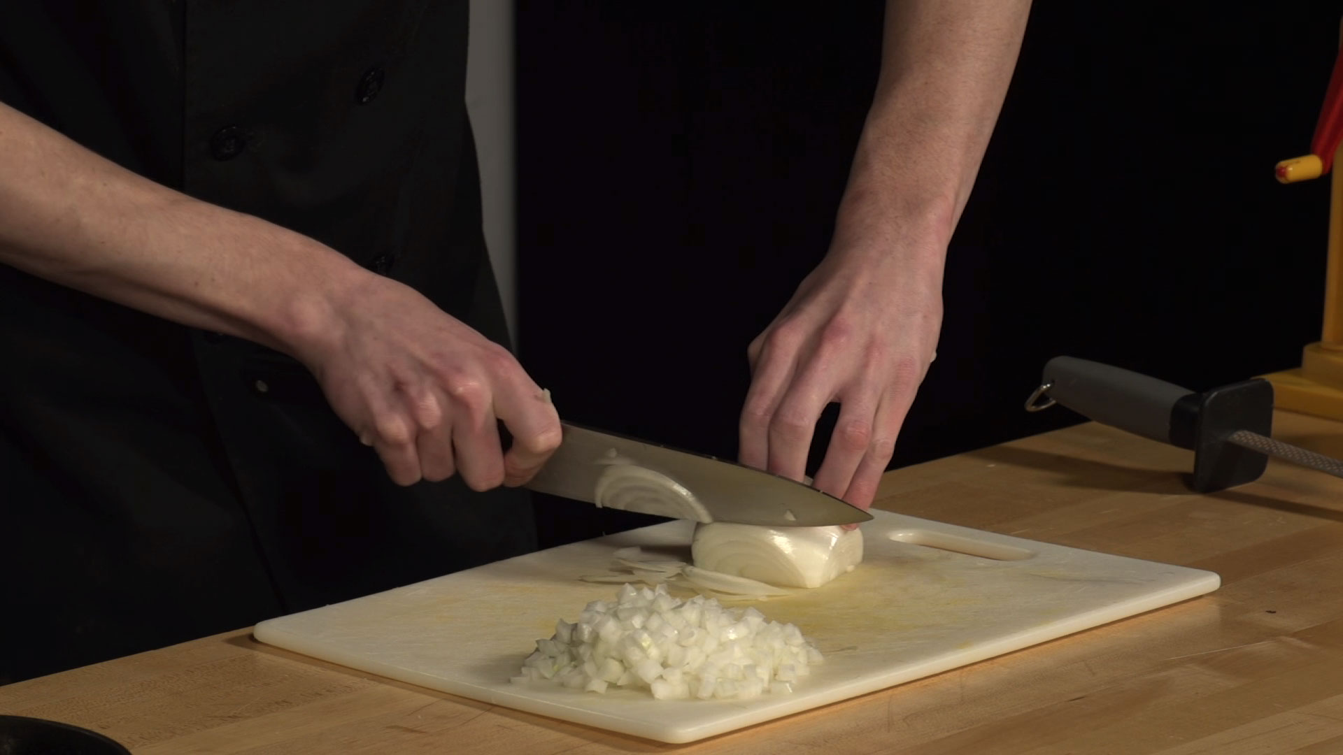knife cutting through an onion