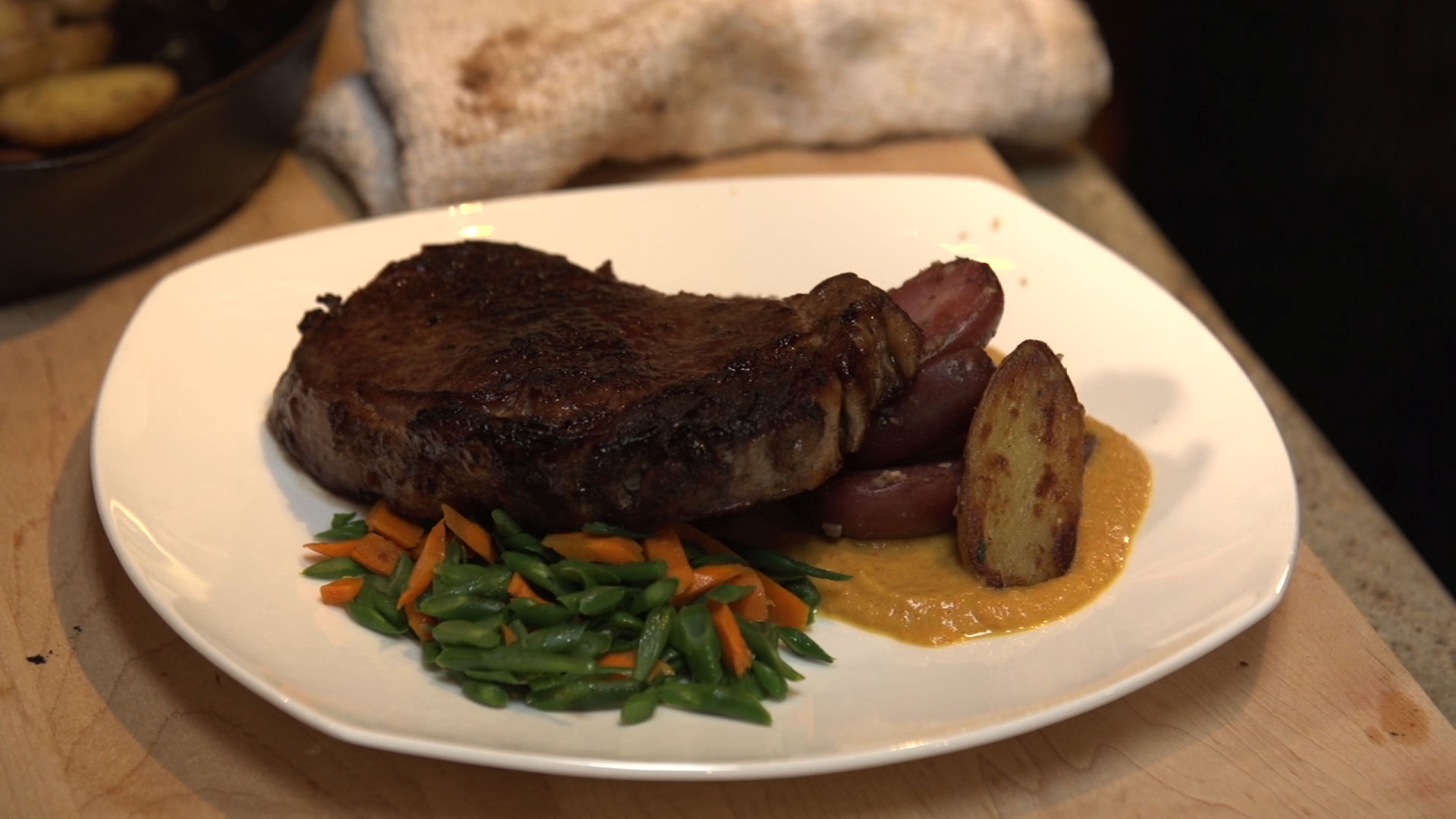 Cooked steak on plate with roasted potatoes