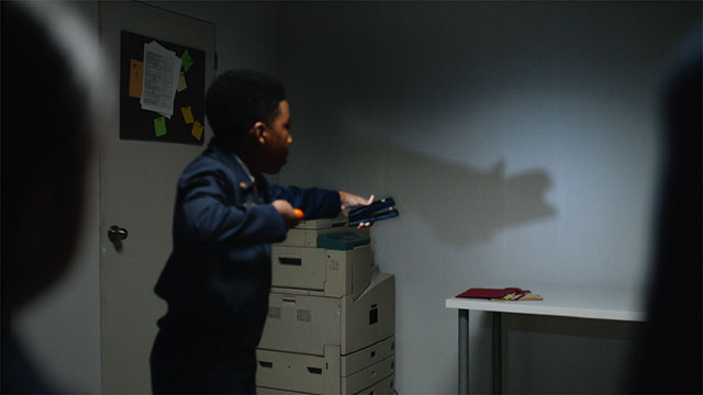 boy makes hand shadow on wall