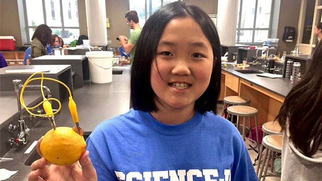 kid holding a lemon battery