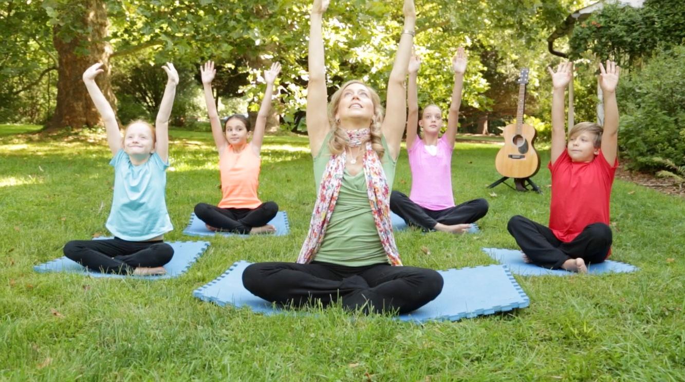 woman with young children doing yoga