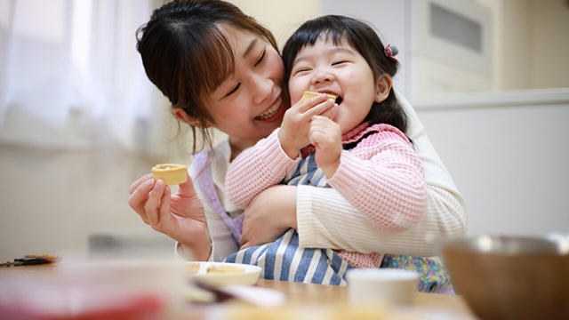 Mother and daughter eating cookies