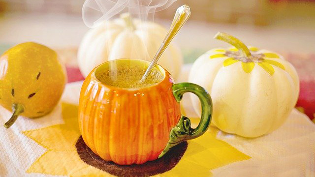 pumpkin coffee cup and small pumpkins