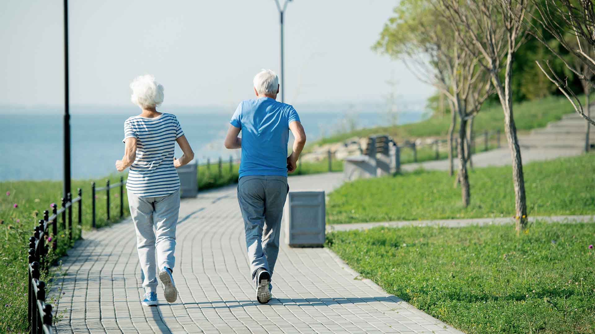 older people jogging in a park