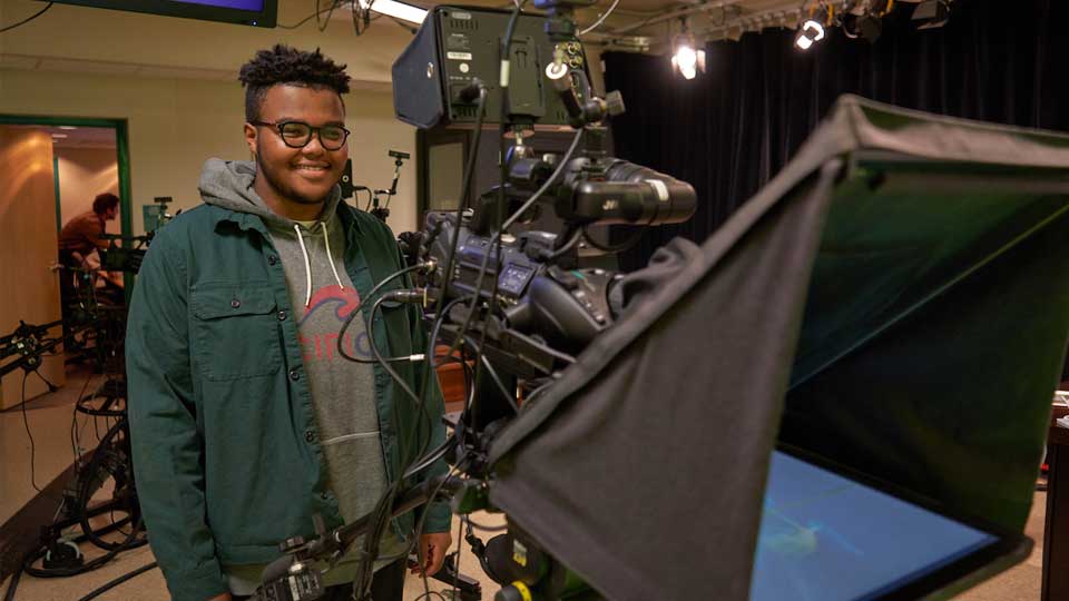 young adult male behind tv camera