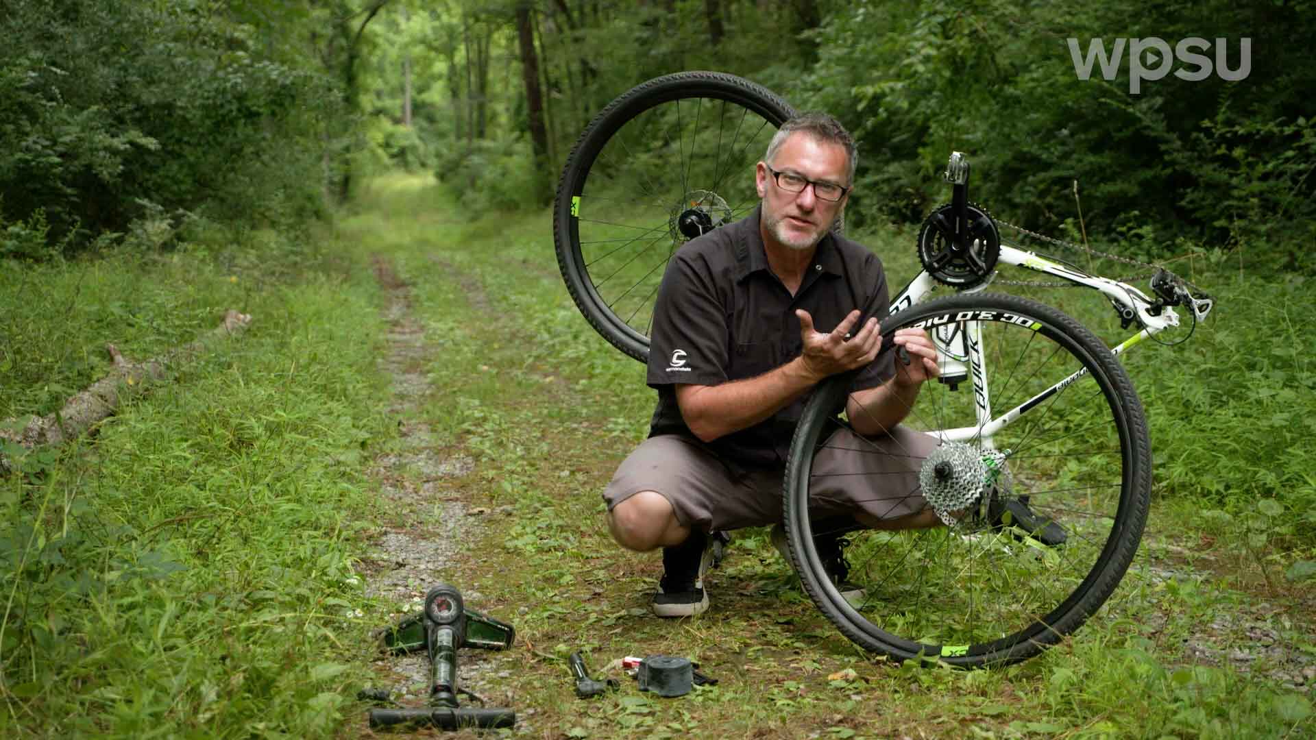 man changing a flat bike tire