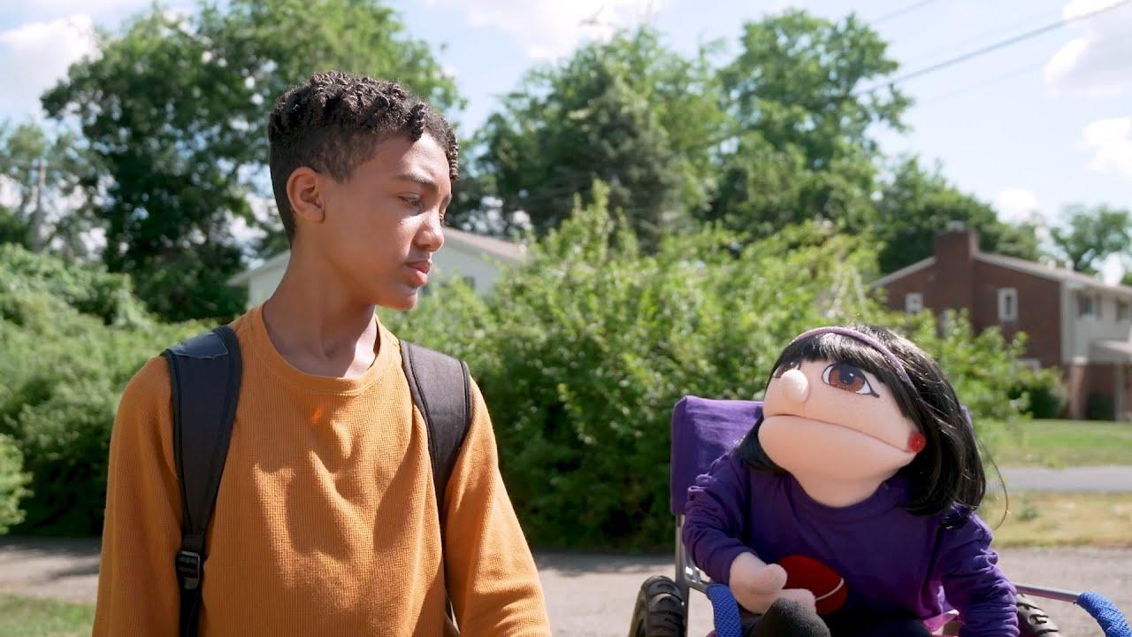 A boy and a puppet talking