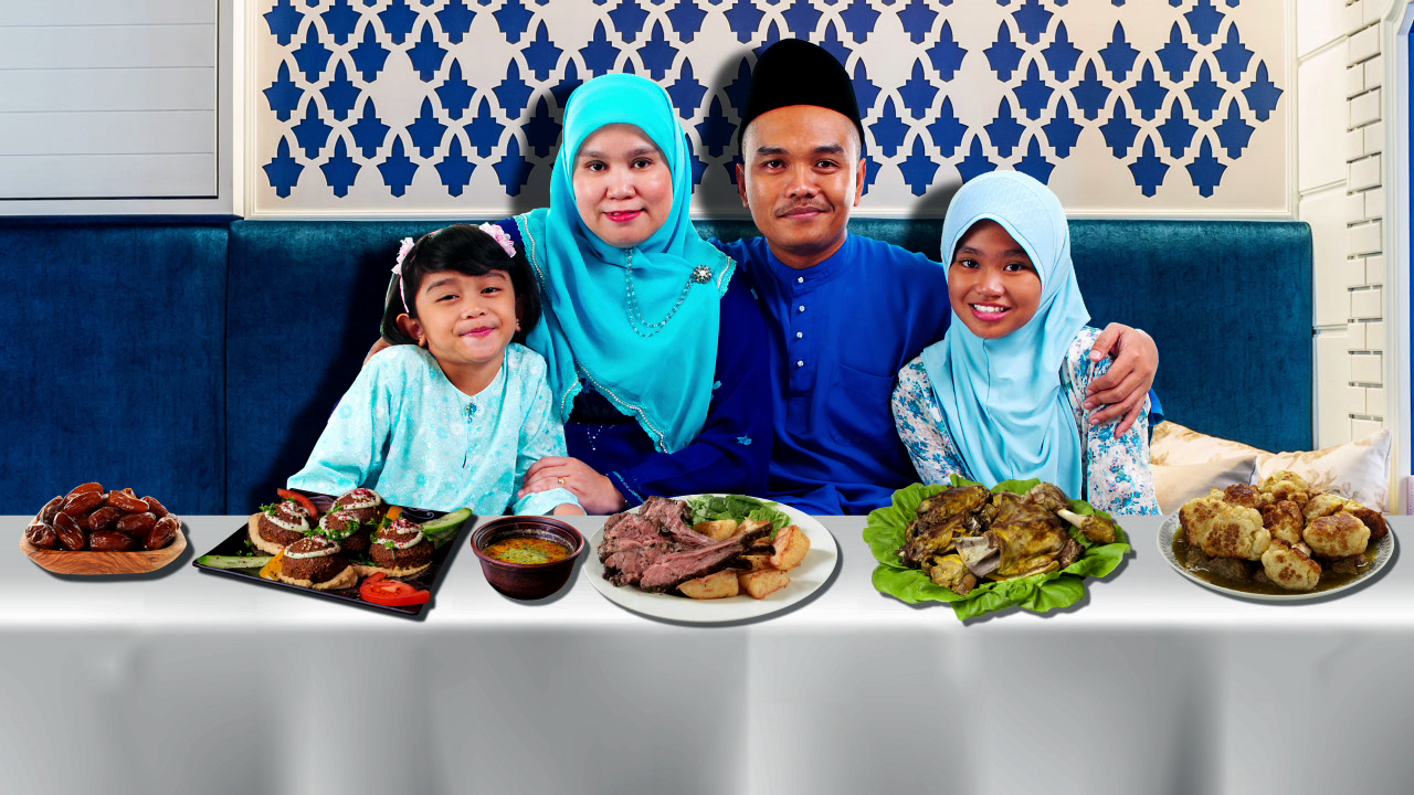 An image of a family in front of a table with food on it.