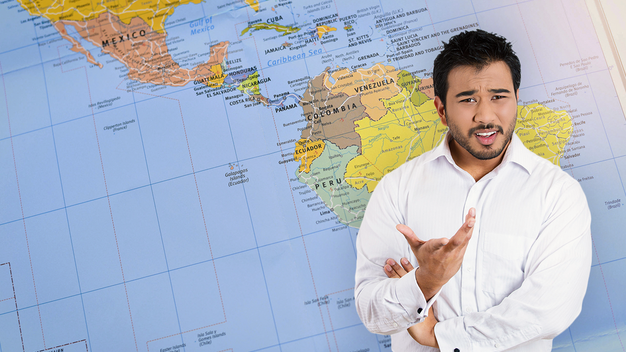 A man in a white shirt stands in front of a map of Central America.