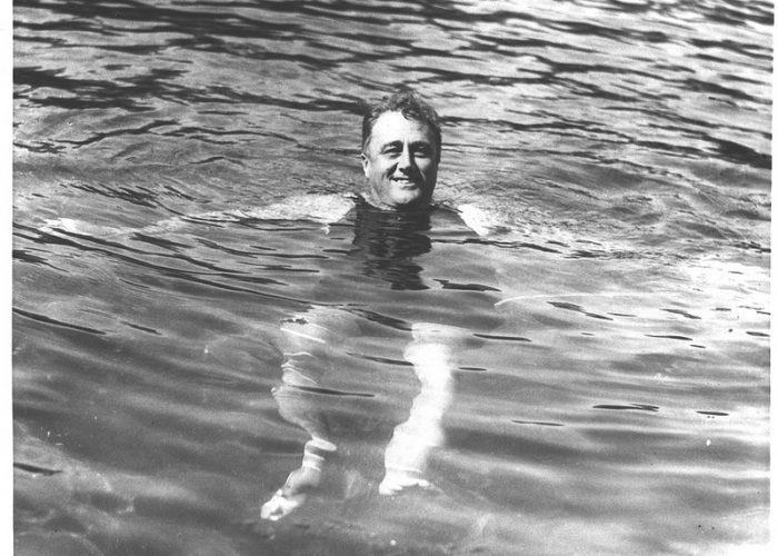 A black-and-white photo of Franklin Delano Roosevelt swimming.