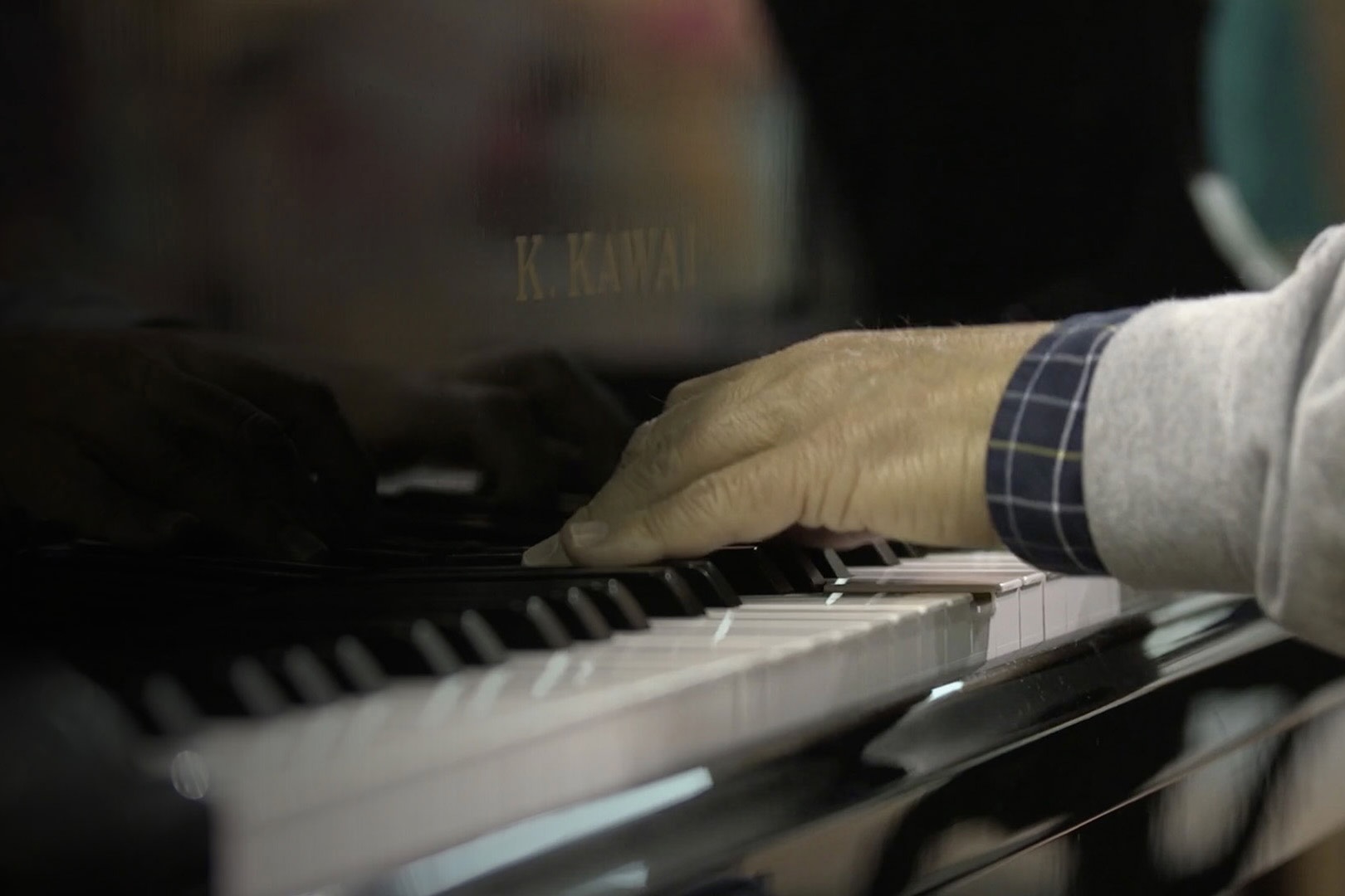 Hands on piano keys.