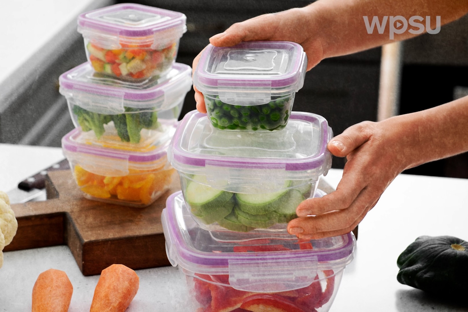Vegetables sealed in storage containers before being placed in a freezer.