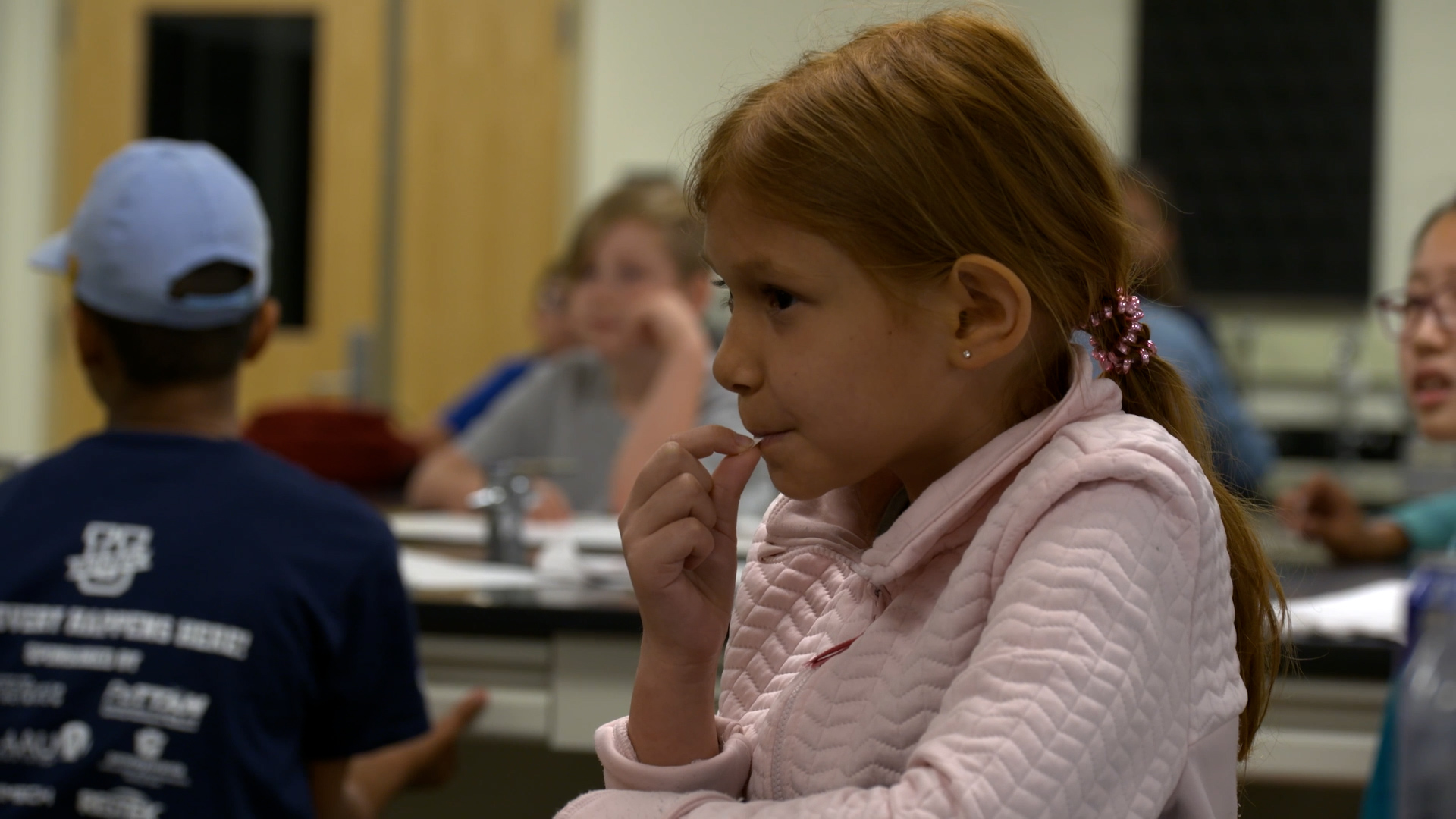 A student placing a taste test sample in their mouth.