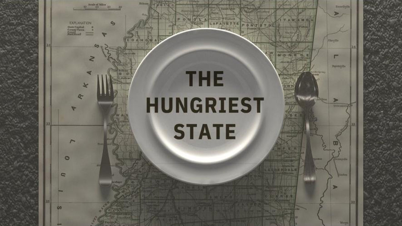 Plate fork and knife sitting atop a map of Alabama with text overlay reading 'The Hungriest State'.