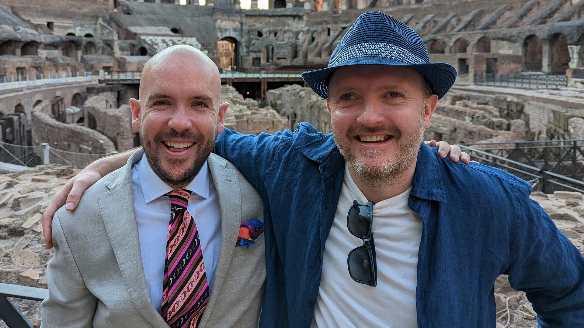 Comedian Chris McCausland standing in front of the Roman Coliseum.