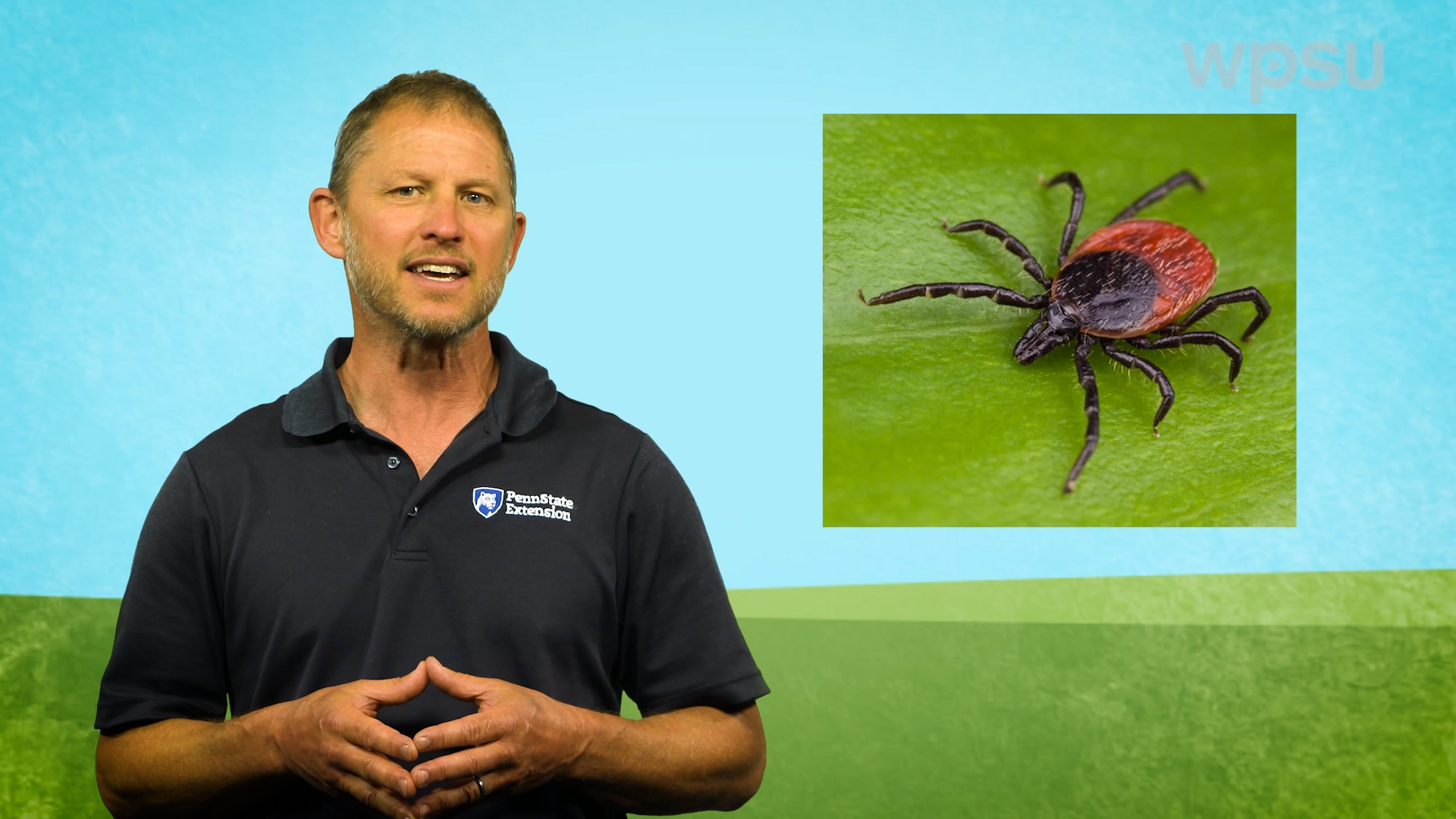 Year-Round Gardening host Tom Butzler standing next to an enlarged image of a tick.