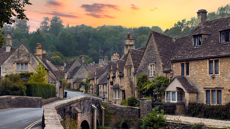 Row of old stone houses on an English countryside.