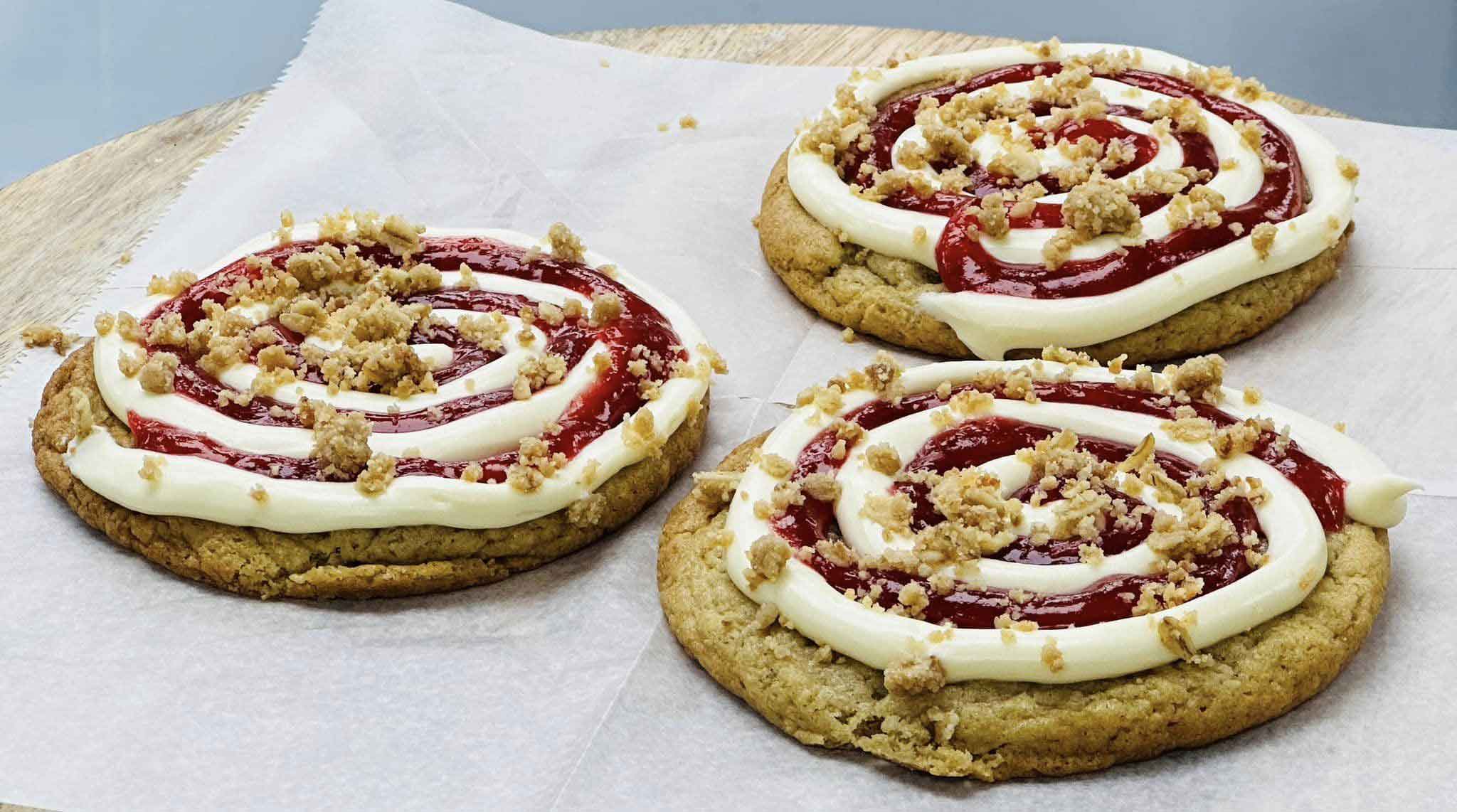 pastries topped with swirled cream and jelly