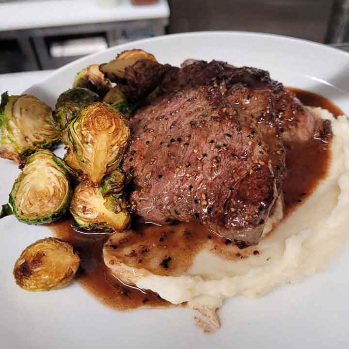 prime rib with mashed potatoes and brussel sprouts